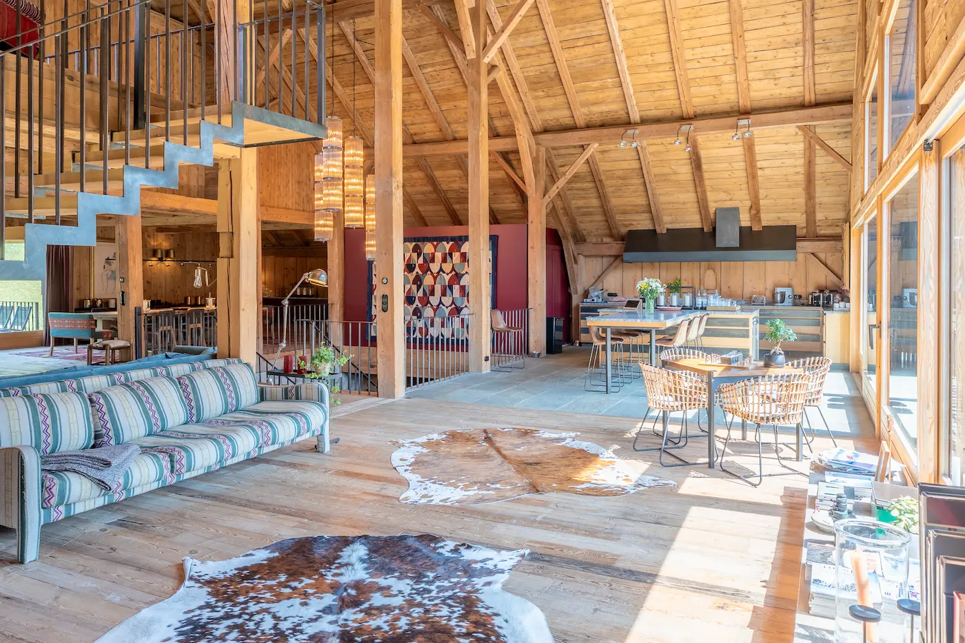 Panoramic view of the living area with a sofa, kitchen, and loft