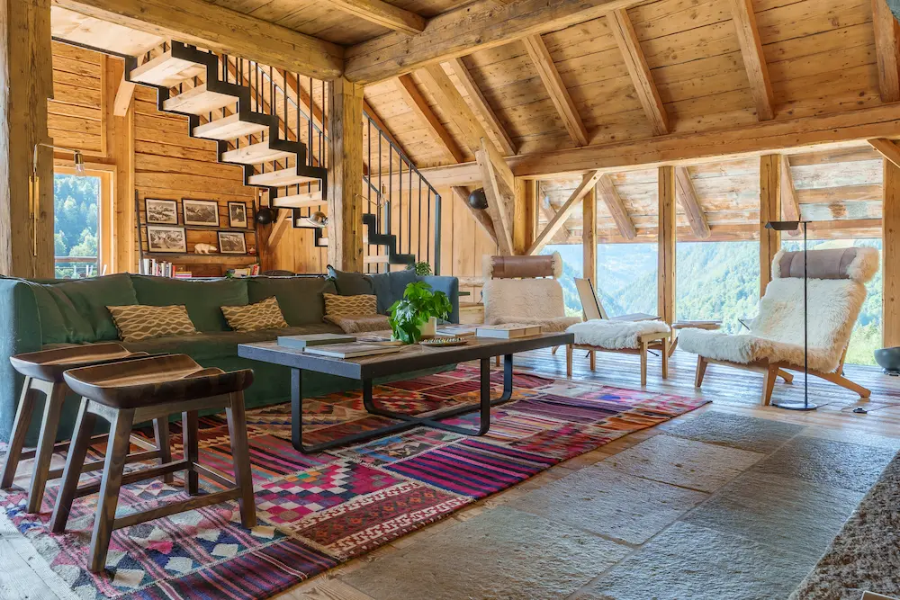 Salon avec escalier fer forgé, dans chalet savoyard